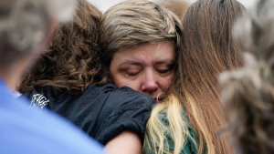 woman hugging her children